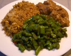 Fried rice, satay and tumis beans plated