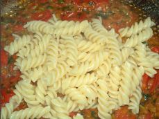Choped shallots, garlic, tomatos, basil and pasta.